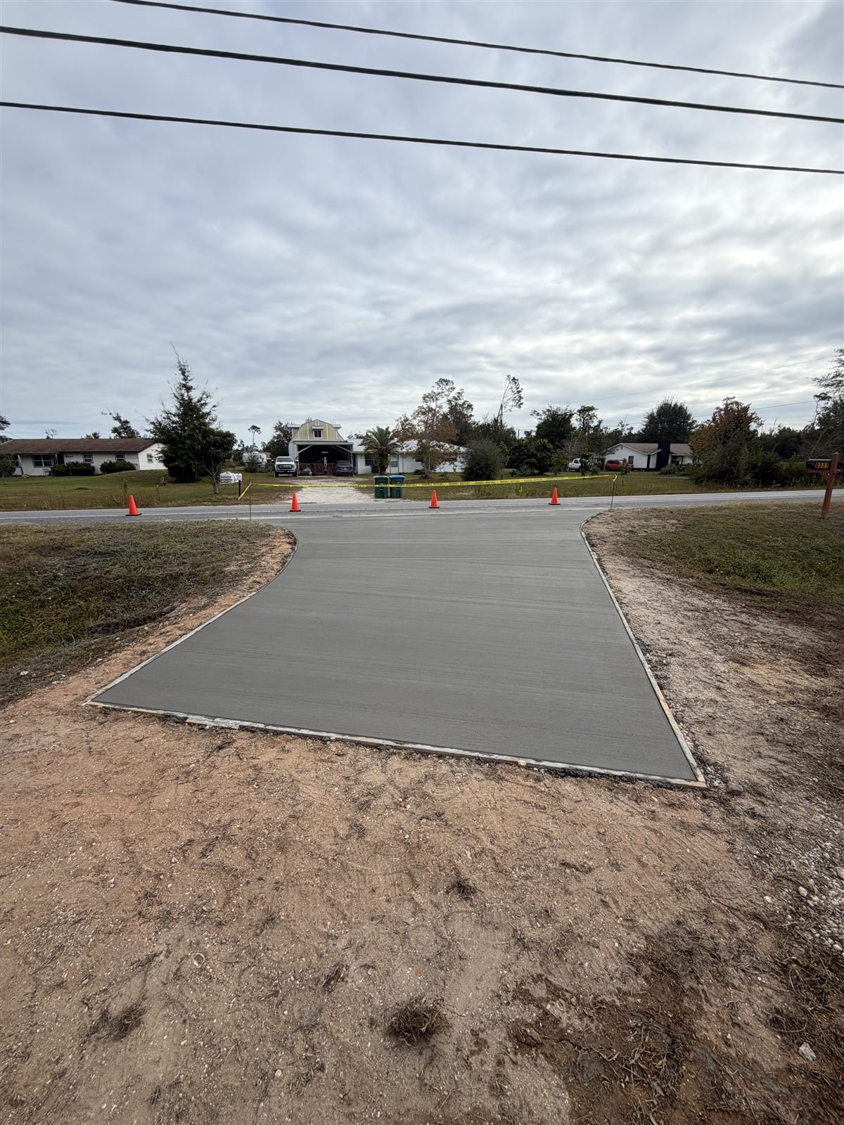 New concrete driveway connecting a property to the road