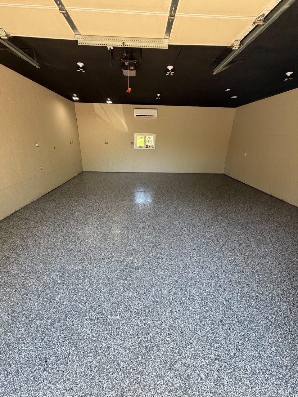Gray epoxy flake flooring across a garage interior