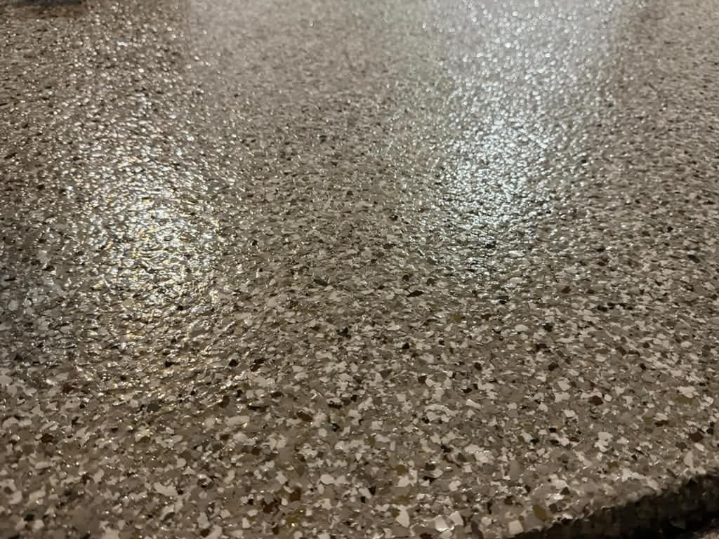 A different color mix of epoxy flakes in a close-up floor finish