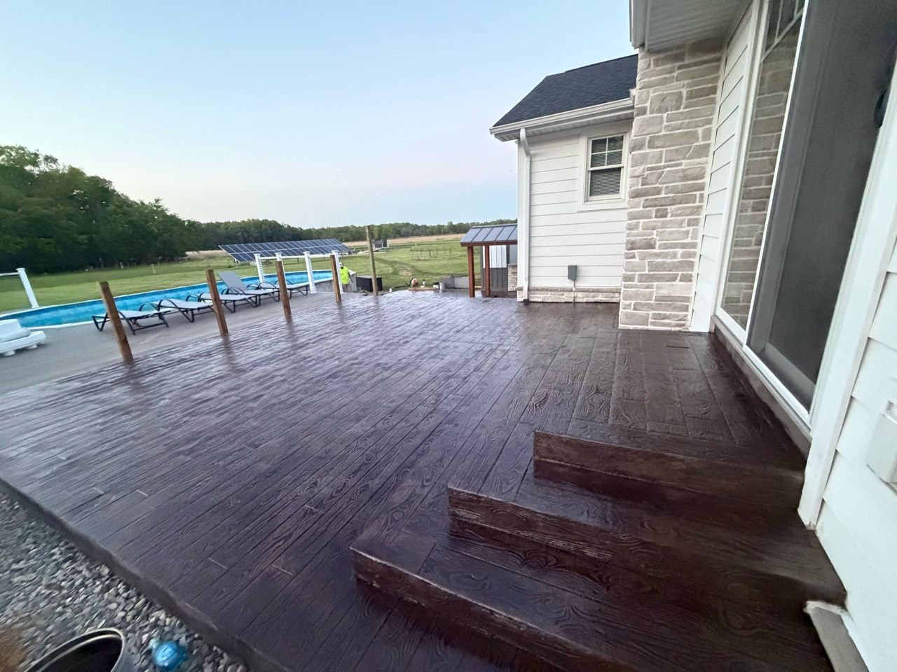 Wood plank stamp concrete extending around exterior steps